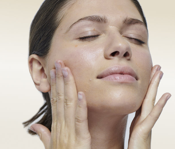 Model applying Gotu Kola on her face