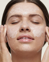 Model applying Products Oat Cleansing Facial Polish