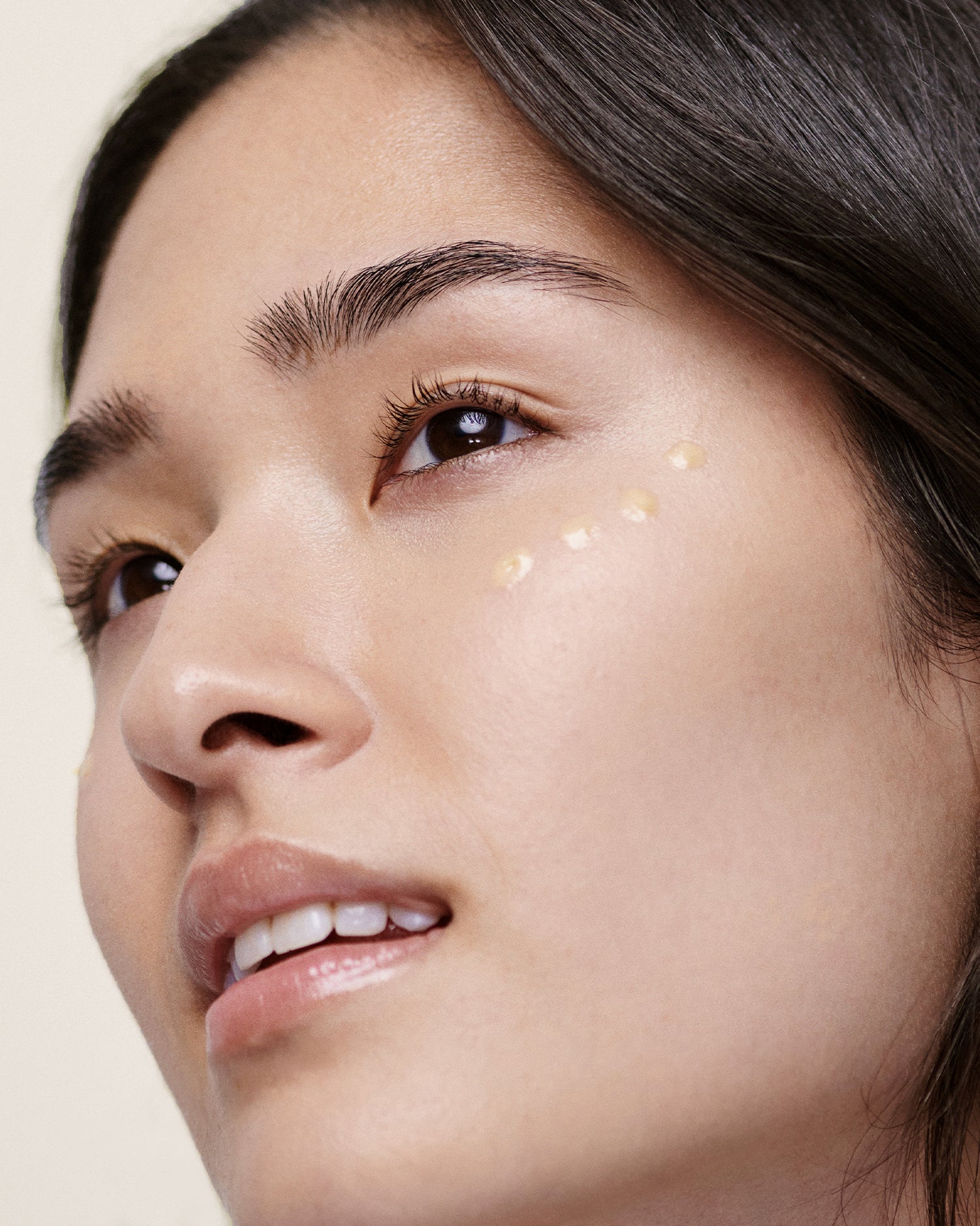 Model applying Argan & Peptide Wrinkle Remedy Eye Cream